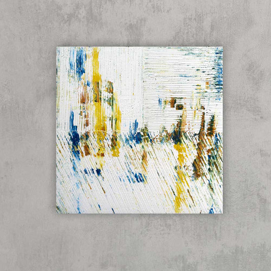 Canvas measures 20x20 inches and features an acrylic-based abstract painting. Color is white, blue, yellow and mustard. Shown on a grey wall.